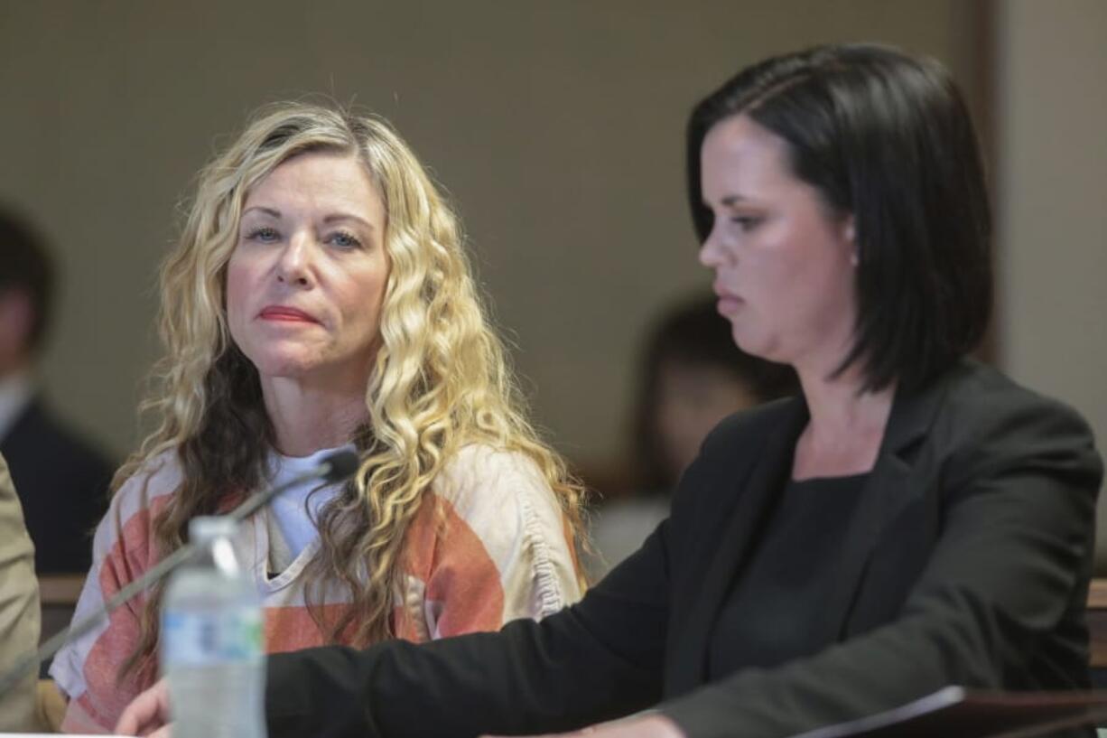 Lori Vallow Daybell glances at the camera during her hearing March 6 in Rexburg, Idaho. The Idaho attorney general has agreed to investigate the mother of two missing children and her husband in connection with the death of his first wife. Daybell is being held in an Idaho jail awaiting trial on charges that she abandoned her two kids, 17-year-old Tylee Ryan and 7-year-old Joshua &quot;JJ&quot; Vallow. The kids disappeared in September.