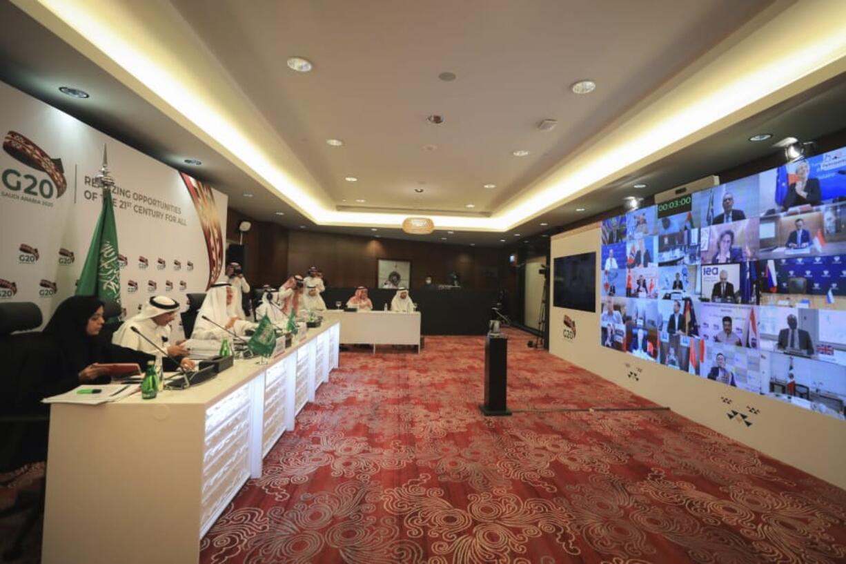 In this photo released by Saudi Energy Ministry, Prince Abdulaziz bin Salman Al-Saud, Minister of Energy of Saudi Arabia, third right, chairs a virtual summit of the Group of 20 energy ministers at his office in Riyadh, Saudi Arabia, Friday, April 10, 2020, to coordinate a response to plummeting oil prices due to an oversupply in the market and a downturn in global demand due to the pandemic.