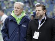 FILE - In this Dec. 30, 2018, file photo, Seattle Seahawks coach Pete Carroll, left, talks with general manager John Schneider before  the team&#039;s NFL football game against the Arizona Cardinals in Seattle. There is a clear and obvious need for the Seahawks to address along the defensive line and it happens to be one of the deeper positions of talent in the entire draft. That may be far too simplistic and straightforward for Schneider and Carroll. Schneider is always good for a few surprises in the draft, and more than a couple of trades.