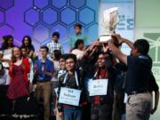 FILE - In this May 31, 2019 file photos, eight co-champions celebrate after winning the Scripps National Spelling Bee, in Oxon Hill, Md. The Scripps National Spelling Bee has been canceled after organizers concluded there was &quot;no clear path to safely set a new date in 2020&quot; because of the coronavirus pandemic.