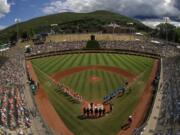 River Ridge, La., lines the third baseline and Curacao lines the first baseline during team introductions before the 2019 Little League World Series Championship game at Lamade Stadium in South Williamsport, Pa. (AP Photo/Gene J.