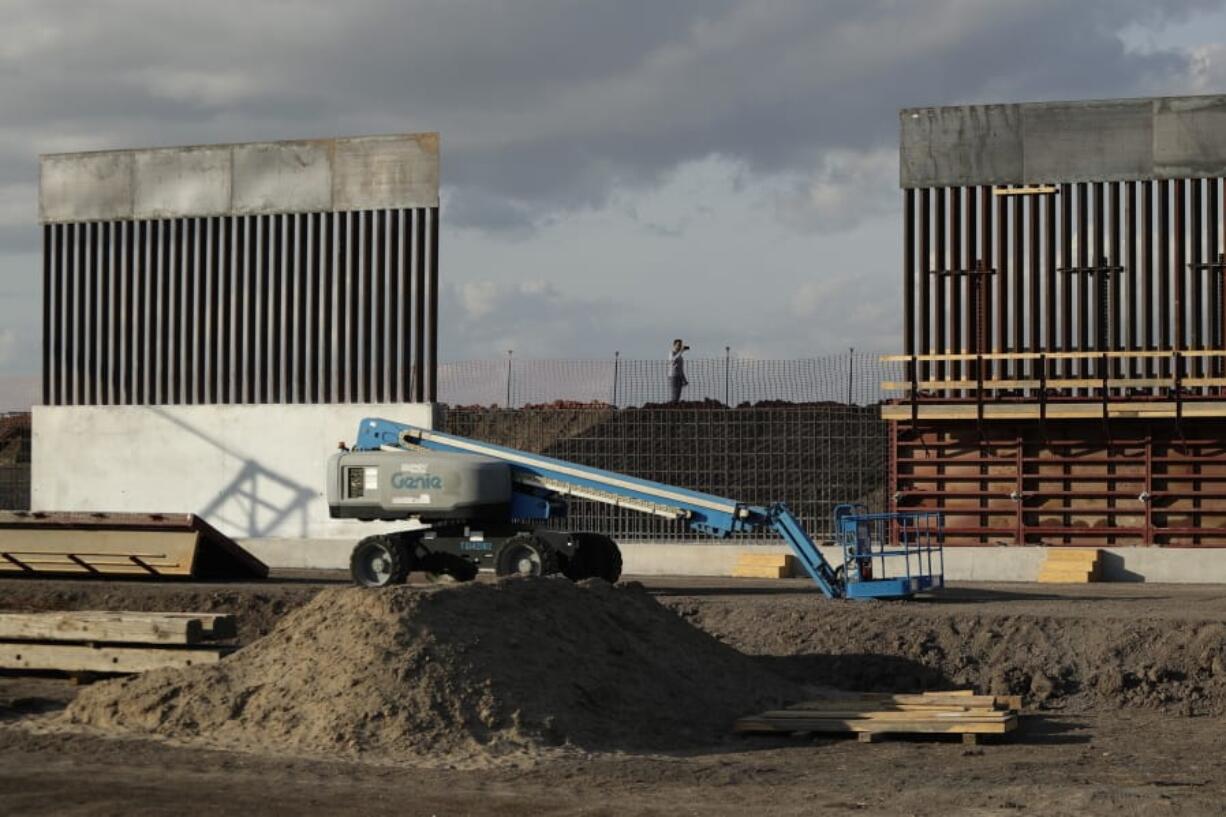 FILE - In this Nov. 7, 2019, file photo, the first panels of levee border wall are seen at a construction site along the U.S.-Mexico border, in Donna, Texas. Major construction projects moving forward along the U.S. borders with Canada and Mexico amid the coronavirus pandemic are raising fears workers could spread the sickness within nearby communities.