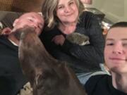 The Pavlik family, Matthew, Rachael, their son Henry, hedgehog Quillie Nelson and German shorthair pointer Mudge, poses April 2 for a photo in their home in Sugar Land, Texas. Many pet owners are taking comfort in their animals as they shelter at home amid the coronavirus pandemic.