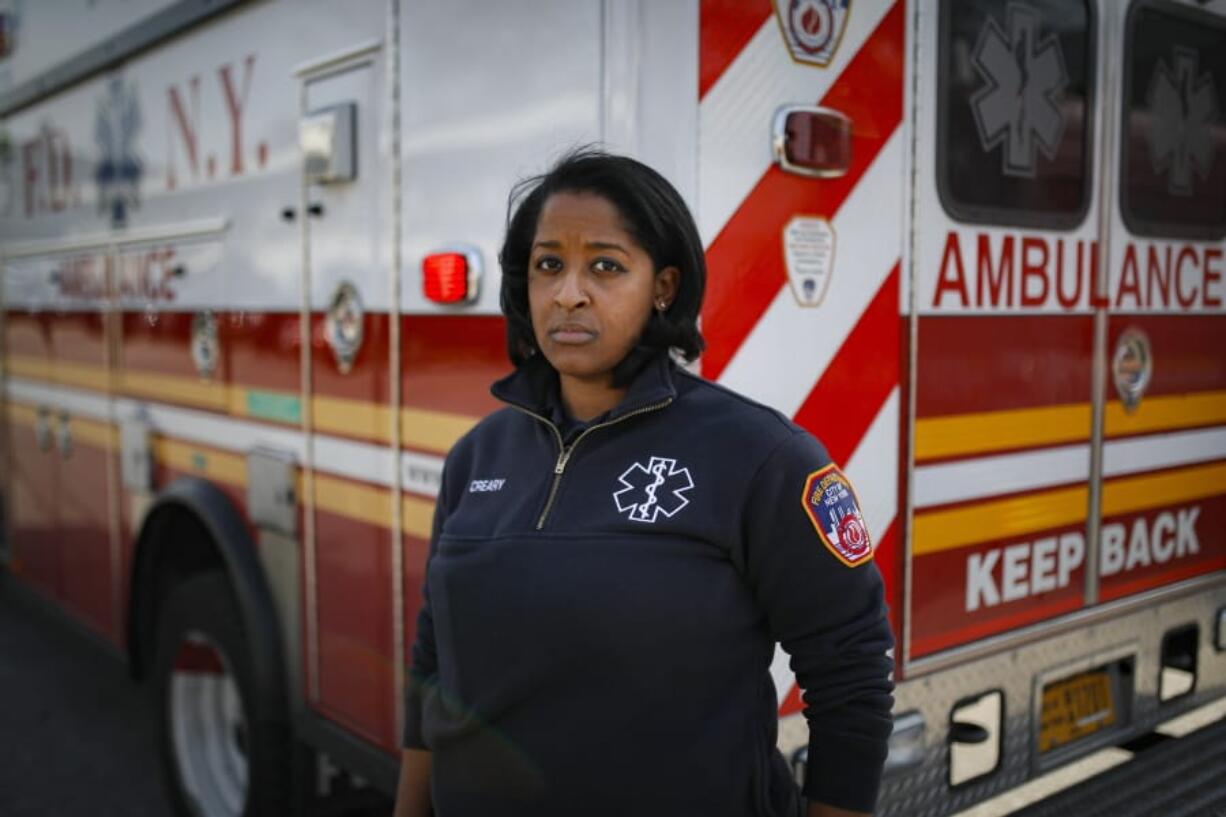 Virginia Creary, a 911 dispatcher, stands Tuesday outside her station house, in the Bronx borough of New York.