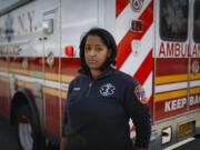 Virginia Creary, a 911 dispatcher, stands Tuesday outside her station house, in the Bronx borough of New York.