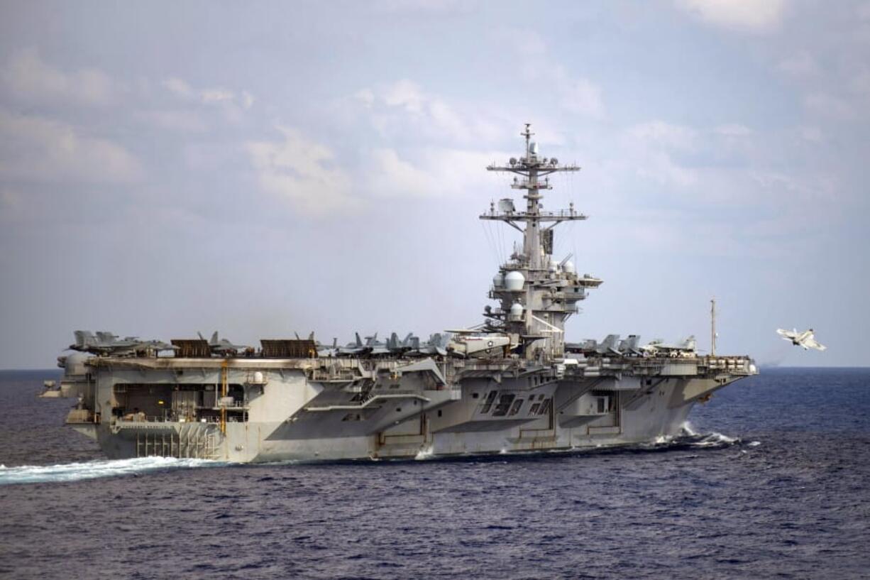 In this March 18, 2020, photo provided by the U.S. Navy, an F/A-18F Super Hornet launches from the flight deck of the aircraft carrier USS Theodore Roosevelt (CVN 71) in the western North Pacific Ocean. (Mass Communication Specialist 3rd Class Nicholas V. Huynh/U.S.