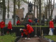 Members of the pro-government Belarussian Patriotic Union of Youth clean monuments Saturday during a subbotnik, a Soviet-style Clean-up Day, in Minsk, Belarus.