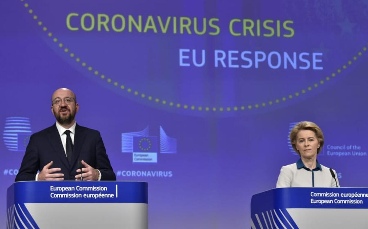 European Commission President Ursula von der Leyen, right, and European Council President Charles Michel participate in a media conference on the European Union response to the COVID-19 crisis at EU headquarters in Brussels, Wednesday, April 15, 2020. The European Union moved Wednesday to head off a chaotic and potentially disastrous easing of restrictions that are limiting the spread of the coronavirus, warning its 27 nations to move very cautiously as they return to normal life and base their actions on scientific advice.