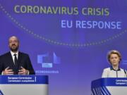 European Commission President Ursula von der Leyen, right, and European Council President Charles Michel participate in a media conference on the European Union response to the COVID-19 crisis at EU headquarters in Brussels, Wednesday, April 15, 2020. The European Union moved Wednesday to head off a chaotic and potentially disastrous easing of restrictions that are limiting the spread of the coronavirus, warning its 27 nations to move very cautiously as they return to normal life and base their actions on scientific advice.