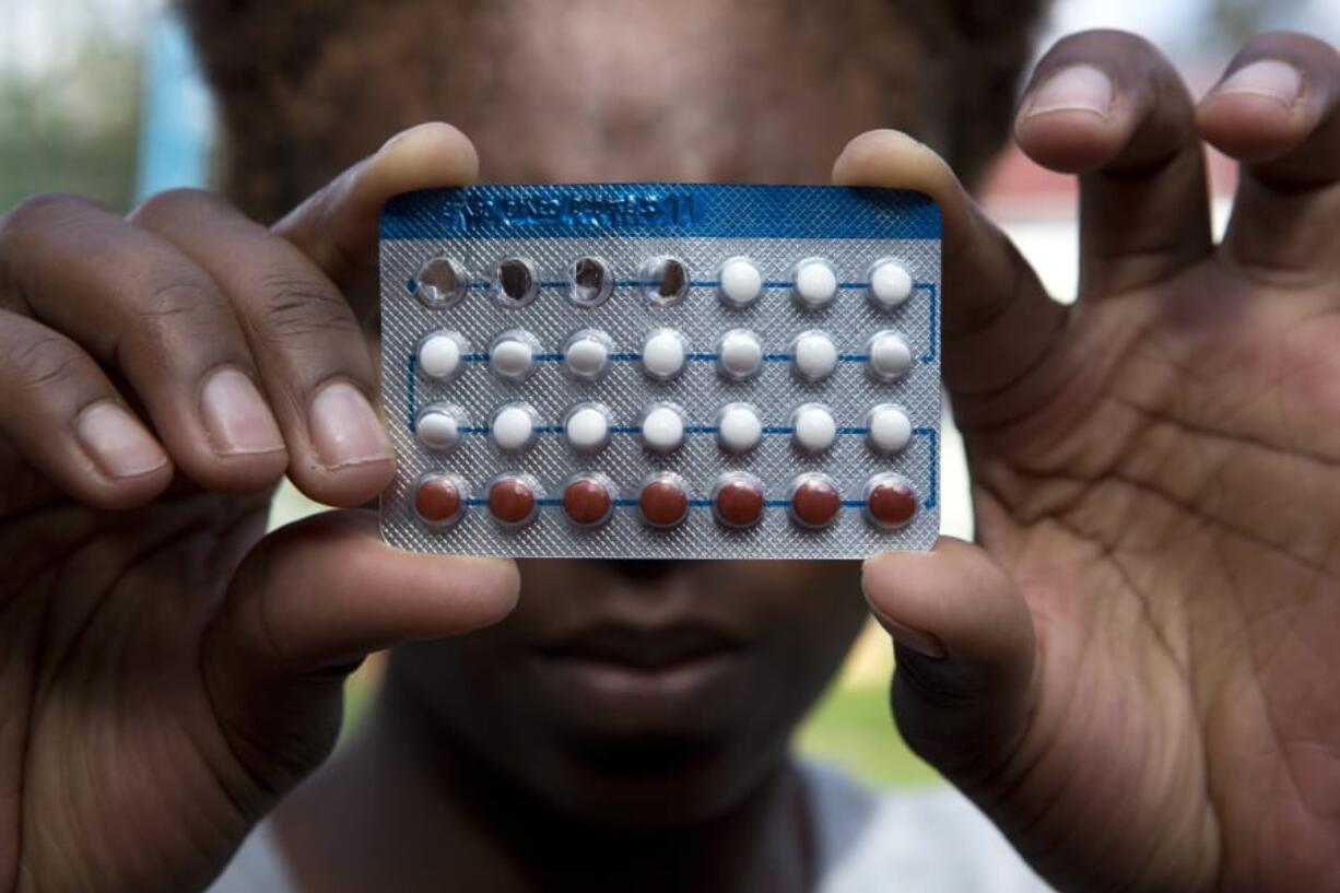 A woman holds a packet of contraceptive pills,  in Harare, Thursday, April 9, 2020. Lockdowns imposed to curb the coronavirus&#039; spread have put millions of women in Africa, Asia and elsewhere out of reach of birth control and other sexual and reproductive health needs. Confined to their homes with husbands and others, they face unwanted pregnancies and little idea of when they can reach the outside world again.