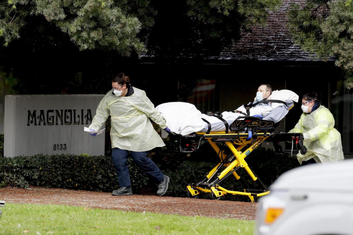 A patient is evacuated from the Magnolia Rehabilitation and Nursing Center in Riverside, Calif., Wednesday, April 8, 2020. More than 80 patients from a Riverside skilled nursing facility are being evacuated this morning to other healthcare locations throughout Riverside County, Calif.