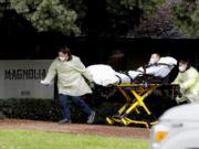 A patient is evacuated from the Magnolia Rehabilitation and Nursing Center in Riverside, Calif., Wednesday, April 8, 2020. More than 80 patients from a Riverside skilled nursing facility are being evacuated this morning to other healthcare locations throughout Riverside County, Calif.