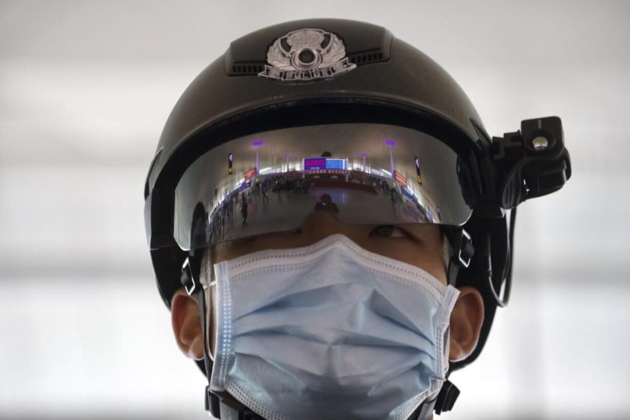 A police officer wearing a face mask to protect against the spread of new coronavirus stands guard at Wuhan Tianhe International Airport in Wuhan in central China&#039;s Hubei Province, Wednesday, April 8, 2020. Within hours of China lifting an 11-week lockdown on the central city of Wuhan early Wednesday, tens of thousands people had left the city by train and plane alone, according to local media reports.