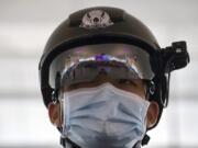 A police officer wearing a face mask to protect against the spread of new coronavirus stands guard at Wuhan Tianhe International Airport in Wuhan in central China&#039;s Hubei Province, Wednesday, April 8, 2020. Within hours of China lifting an 11-week lockdown on the central city of Wuhan early Wednesday, tens of thousands people had left the city by train and plane alone, according to local media reports.