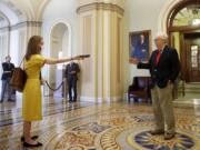 Senate Majority Leader Mitch McConnell of Ky., right, speaks with a reporter outside the Senate chamber on Capitol Hill in Washington, Thursday, April 9, 2020. Senate Democrats on Thursday stalled President Donald Trump&#039;s request for $250 billion to supplement a &quot;paycheck protection&quot; program for businesses crippled by the coronavirus outbreak, demanding protections for minority-owned businesses and money for health care providers and state and local governments.