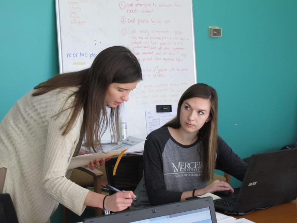 Medical student Catherine Waldron talks with epidemiologist Elizabeth Goff at the Georgia Department of Public Health&#039;s district office in Savannah, Ga.,, on Wednesday Waldron is among about 30 medical students helping with contact tracing.