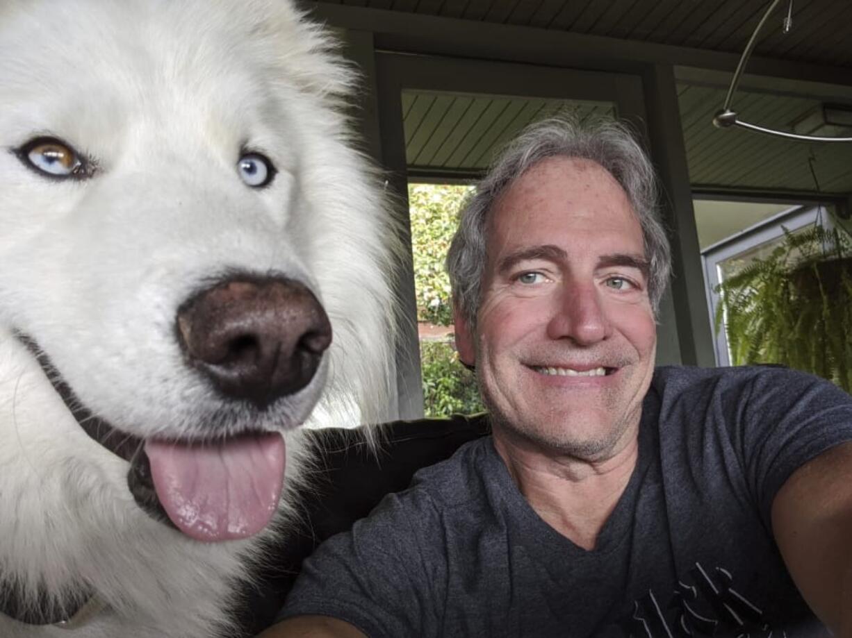 Michael Liedtke poses April 5 with Wookiee, his newly adopted dog, while sheltering in place in Berkeley, Calif. While millions of people are stuck in their homes, there are abandoned dogs and cats still looking for one.