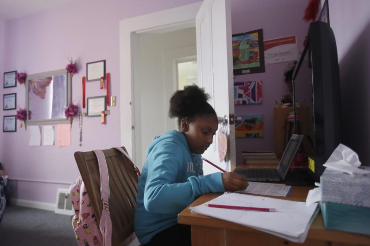 FILE - In this April 9, 2020, file photo, Sunnyside Elementary School fourth-grader Miriam Amacker does school work in her room at her family&#039;s home in San Francisco. Teachers across the country report their attempts at distance learning induced by the pandemic are failing to reach large numbers of students.