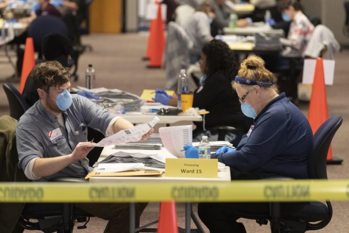 City of Milwaukee Election Commission workers process absentee ballots in Wisconsin&#039;s presidential primary election, Tuesday, April 7, 2020, in Milwaukee, Wis.