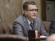 FILE - In this Feb. 19, 2020 photo, state Rep. Matt Shea, R-Spokane Valley, listens to testimony on the House floor at the Capitol in Olympia, Wash. Prominent state lawmaker Shea says the coronavirus is a foreign bio-weapon and claims Marxists are using the pandemic to advance totalitarianism. (AP Photo/Ted S.