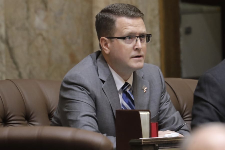 FILE - In this Feb. 19, 2020 photo, state Rep. Matt Shea, R-Spokane Valley, listens to testimony on the House floor at the Capitol in Olympia, Wash. Prominent state lawmaker Shea says the coronavirus is a foreign bio-weapon and claims Marxists are using the pandemic to advance totalitarianism. (AP Photo/Ted S.