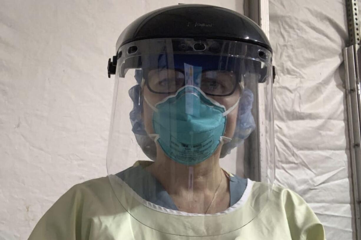 This Tuesday, March 31, 2020 photo provided by emergency room nurse Cynthia Riemer shows her at the University of Illinois Hospital in Chicago, wearing a welder&#039;s mask from a hardware store and other hospital-issued protective gear. Nurses are supplementing their hospital PPE with items such as the welder&#039;s mask to conserve hospital supplies.