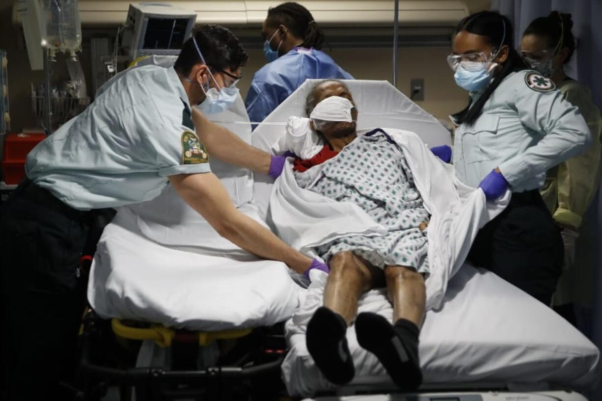 FILE - In this Monday, April 20, 2020, file photo, emergency medical technicians transport a patient from a nursing home to an emergency room bed at St. Joseph&#039;s Hospital in Yonkers, N.Y. After two months and 10,000 deaths that have made the nation&#039;s nursing homes the worst places to be during the coronavirus crisis, most of them still don&#039;t have access to enough tests to help control outbreaks among their frail, elderly residents.