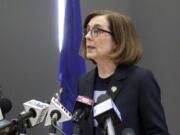 FILE - In this March 16, 2020, file photo, Oregon Gov. Kate Brown speaks at a news conference in Portland, Ore., to announce a four-week ban on eat-in dining at bars and restaurants, due to COVID-19, throughout the state. Oregon is in its fourth week of lockdown. Oregonians can&#039;t enter state parks in mountains and in valleys now blooming with springtime flowers, or go to the state&#039;s trademark wineries and microbreweries. But Oregon appears to be an outlier as coronavirus cases start to peak in each state. Of all the states in America, Oregon should have the fewest COVID-19 deaths per capita when the peak comes here, according to researchers at the University of Washington who developed a closely watched model.