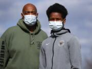 Washtenaw County Sheriff&#039;s Department Sgt. Eugene Rush, who was diagnosed with the coronavirus near the end of March, stands with his son, Joshua, 16, on Thursday in Superior Township, Mich. Joshua has also been diagnosed with COVID-19, are both on the mend and resting at home.