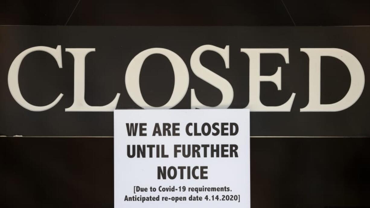 FILE - In this April 2, 2020 file photo, a notice of closure is posted at The Great Frame Up in Grosse Pointe Woods, Mich.  The government is closing in on the $349 billion lending limit on its Paycheck Protection Program that is sending relief money to the nation&#039;s small businesses. The Small Business Administration says that it has approved more than 1.6 million loans worth more than $339 billion. The program will likely reach its ceiling Thursday, April 16.