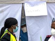 A health worker wearing personal protective gear inside a testing tent, gestures colleagues during the screening and testing for COVID-19, in Lenasia, south of Johannesburg, South Africa, Wednesday, April 8, 2020. South Africa and more than half of Africa&#039;s 54 countries have imposed lockdowns, curfews, travel bans or other restrictions to try to contain the spread of COVID-19. The new coronavirus causes mild or moderate symptoms for most people, but for some, especially older adults and people with existing health problems, it can cause more severe illness or death.