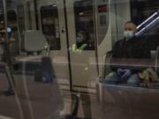 Commuters wearing face masks to protect against coronavirus at Atocha train station in Madrid, Spain, Monday, April 13, 2020. Confronting both a public health emergency and long-term economic injury, Spain is cautiously re-starting some business activity to emerge from the nationwide near-total freeze that helped slow the country&#039;s grim coronavirus outbreak. The new coronavirus causes mild or moderate symptoms for most people, but for some, especially older adults and people with existing health problems, it can cause more severe illness or death.