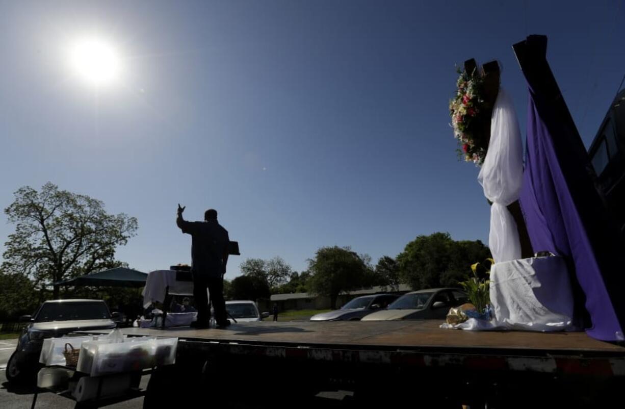 Pastor Albert &quot;Gonzo&quot; Gonzales stands on a flat-bed truck as his church holds Easter services in the parking log in San Antonio, Sunday, April 12, 2020. Many churches are adapting their services as Christians around the world are celebrating Easter at a distance due to the COVID-19 pandemic.