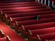 A man prays while attending an Easter service at Trinity Baptist Church in San Antonio, Sunday, April 12, 2020. Many churches are adapting their services as Christians around the world are celebrating Easter at a distance due to the COVID-19 pandemic.