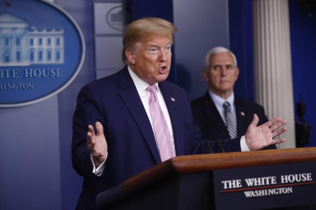 President Donald Trump speaks during a coronavirus task force briefing at the White House, Saturday, April 4, 2020, in Washington. Vice President Mike Pence listens at left. Earlier, Trump met by phone with many U.S. pro sports leaders to discuss how that industry has been affected by the global coronavirus pandemic.