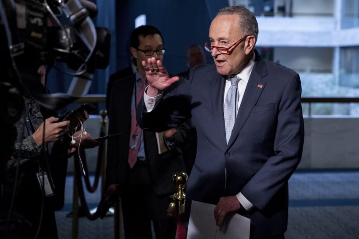 FILE - In this March 20, 2020, file photo Senate Minority Leader Sen. Chuck Schumer of N.Y., speaks to reporters as he arrives for a meeting to discuss the coronavirus relief bill on Capitol Hill Washington. The Trump administration and Congress are nearing an agreement as early as Sunday, April 19, on a $400-plus billion aid package to boost a small-business loan program that has run out of money and add funds for hospitals and COVID-19 testing.