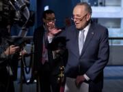 FILE - In this March 20, 2020, file photo Senate Minority Leader Sen. Chuck Schumer of N.Y., speaks to reporters as he arrives for a meeting to discuss the coronavirus relief bill on Capitol Hill Washington. The Trump administration and Congress are nearing an agreement as early as Sunday, April 19, on a $400-plus billion aid package to boost a small-business loan program that has run out of money and add funds for hospitals and COVID-19 testing.