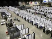 Rows of patient beds are shown at a military field hospital, Sunday, April 5, 2020, at the CenturyLink Field Event Center in Seattle. Officials said the facility, which will be used for people with medical issues that are not related to the new coronavirus outbreak, has more than 200 beds and is ready now to receive patients. (AP Photo/Ted S.