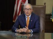 Washington Gov. Jay Inslee sits at his desk and rehearses a speech April 21 at the Capitol in Olympia, Wash., minutes before going live to address the public on the state&#039;s next steps in addressing the coronavirus outbreak. (AP Photo/Ted S.