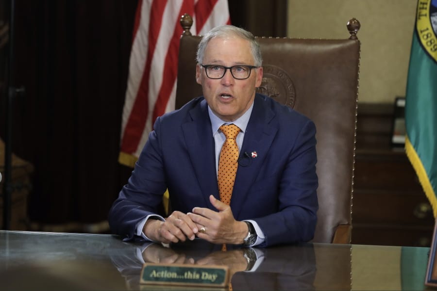 Washington Gov. Jay Inslee sits at his desk and rehearses a speech April 21 at the Capitol in Olympia, Wash., minutes before going live to address the public on the state&#039;s next steps in addressing the coronavirus outbreak. (AP Photo/Ted S.