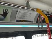 A &quot;Poetry Moves&quot; placard on a C-Tran bus.