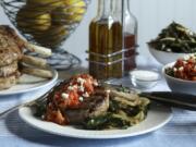 Pork chops are served with a roasted red pepper and feta cheese relish, plus a side of sauteed greens.