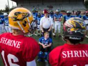 East All-Stars honorary captain Andrew Norton, 11, of Vancouver, is escorted by Shriner Bob Hitchcock, of Vancouver, for the coin toss before the start of the 2019 Freedom Bowl Classic at McKenzie Stadium. The 2020 game has been postponed until 2021 due to health concerns from the coronavirus pandemic.