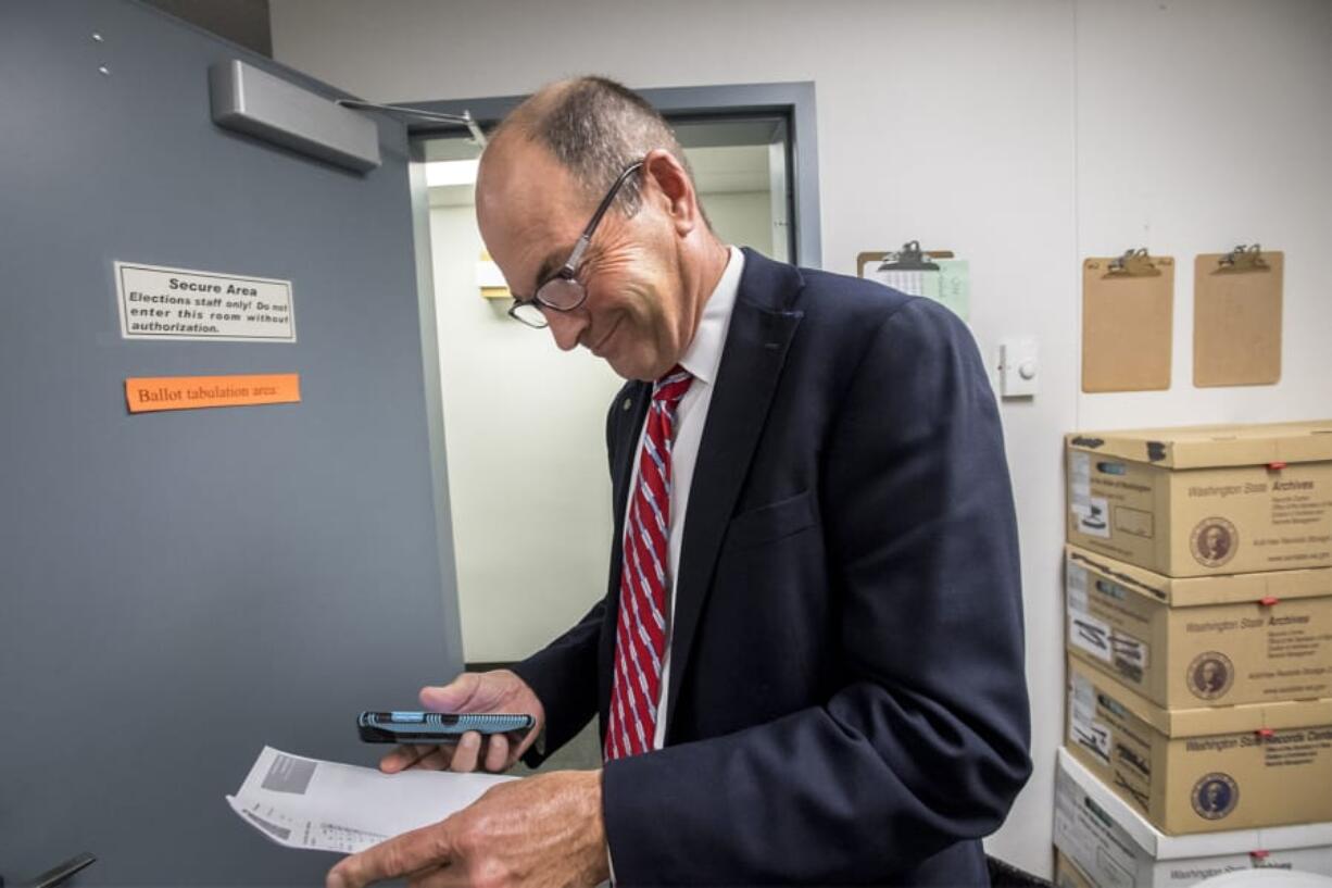 Clark County Auditor Greg Kimsey views the first primary election result printout for the 2020 elections in the ballot tabulation room of the Clark County Election Office in August.