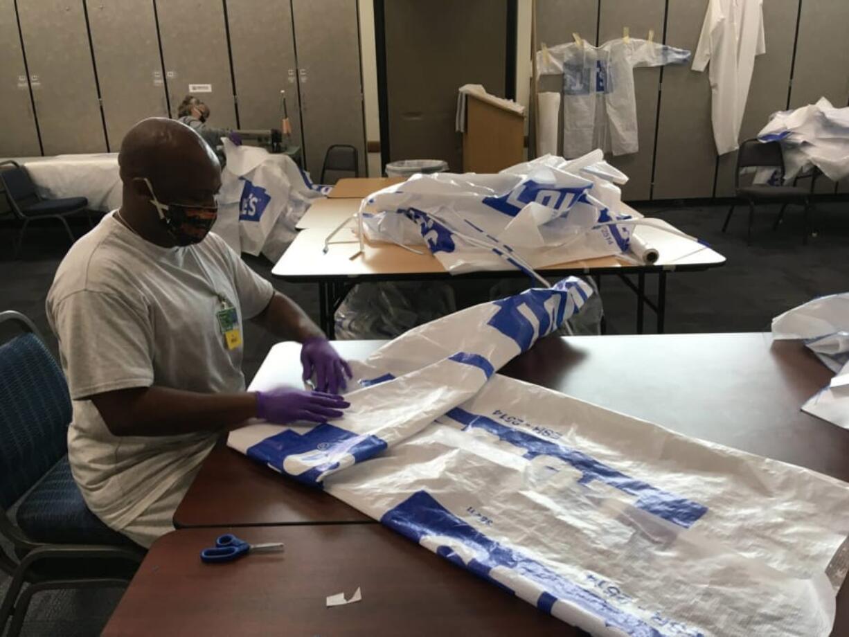 A member of the Washington Corrections Center for Women&#039;s Sisters of Charity folds a gown to be donated to area fire and rescue.