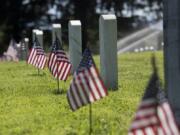 Afternoon sun illuminates American flags placed in preparation for Memorial Day at Vancouver Barracks Post Cemetery on May 23, 2019.