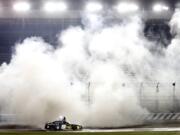 Chase Elliott does a burnout after winning the NASCAR Cup race Thursday at Charlotte Motor Speedway.