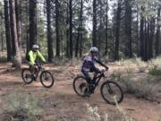 Mountain bikers ride the Catch and Release Trail southwest of Bend, Ore.