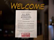 A sign on a business considered nonessential by Gov. Jay Inslee notifies customers of its closure in downtown Vancouver on March 27.