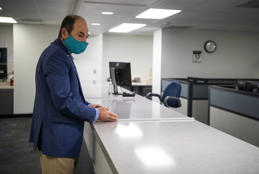 Clark County Auditor Greg Kimsey describes Friday the new glass screens that will be set up to help protect employees at the county elections office.